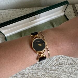 Gucci Women's Black and Gold Watch